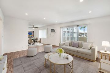 Sherman Oaks apartment for rent - A living room with a white couch, a coffee table, and a painting on the wall.