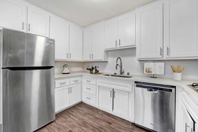 Sherman Oaks apartment for rent - A kitchen with white cabinets and a stainless steel refrigerator.