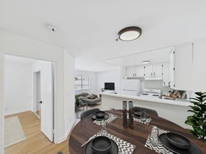 Los Angeles apartment for rent - A modern dining room with a wooden table set for a meal.