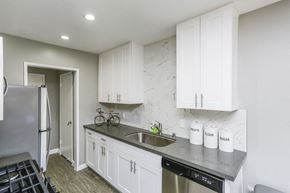 Los Angeles apartment for rent - A kitchen with white cabinets and a black dishwasher.