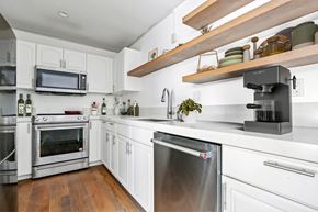 Santa Monica apartment for rent - a kitchen with white cabinets and stainless steel appliances