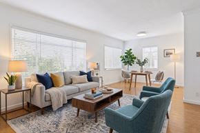 West Hollywood apartment for rent - A living room with a grey couch, a blue chair, and a wooden coffee table.