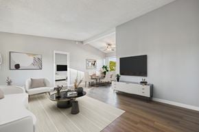 North Hollywood apartment for rent - A living room with a white couch, a coffee table, and a flat screen TV.