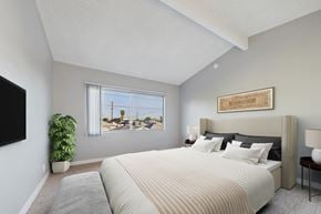 North Hollywood apartment for rent - A bedroom with a large bed and a flat screen TV mounted on the wall.