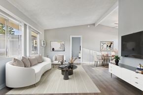 North Hollywood apartment for rent - A modern living room with a white sofa and a coffee table.