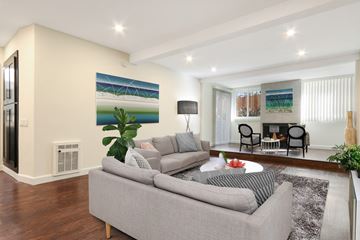 Los Angeles apartment for rent - A living room with a grey couch and a painting on the wall.