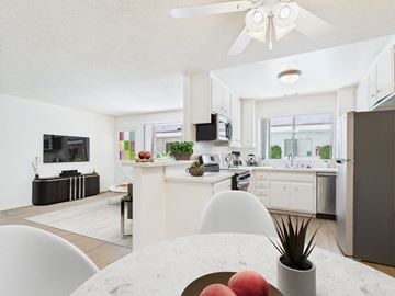 Encino apartment for rent - A modern kitchen with a dining table and chairs in the foreground.