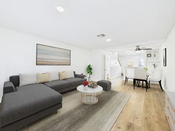Los Angeles apartment for rent - A living room with a grey sofa, a white coffee table, and a painting on the wall.