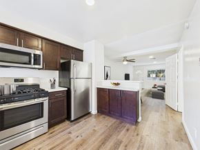 Los Angeles apartment for rent - A kitchen with a stove top oven and a refrigerator.