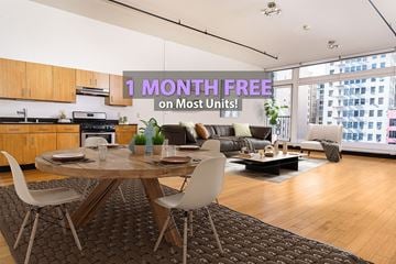 Los Angeles apartment for rent - A modern living room with a dining table and chairs is on sale for 1 month free on most units.