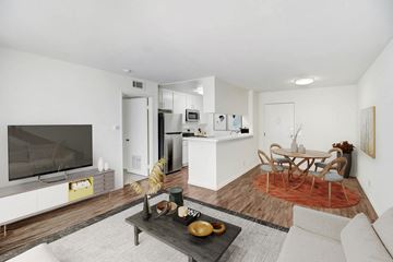 Northridge apartment for rent - A modern living room with a white couch and a wooden coffee table.