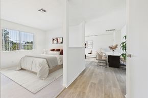 North Hollywood apartment for rent - A bedroom with a bed and a chair in it.