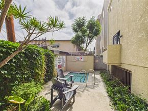 North Hollywood apartment for rent - A small pool surrounded by a concrete patio and a black metal railing.