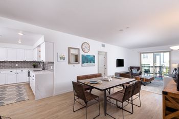 Wood plank-style flooring in living room, kitchen, and bathrooms