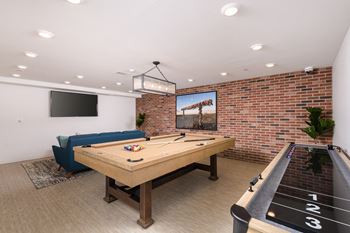 “The lounge” - community lounge featuring a tv viewing area, pool table, and shuffleboard table