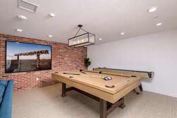 “The lounge” - community lounge featuring a tv viewing area, pool table, and shuffleboard table
