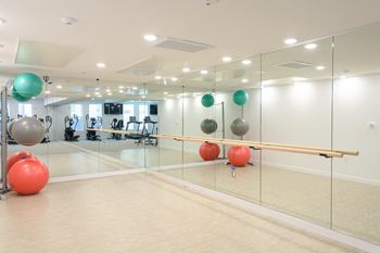 “The gym” – fitness center with cardio equipment, free weights, and dedicated stretching/yoga area