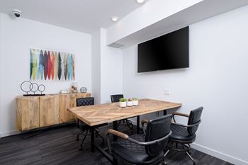 “The office” - collaborative workspace with conference table and television