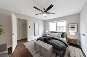 Burbank apartment for rent - A modern bedroom with a large bed and a ceiling fan.