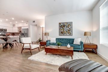 Santa Clarita apartment for rent - A living room with a blue couch and a white rug.