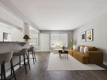 Los Angeles apartment for rent - A living room with a brown couch and a white chair.