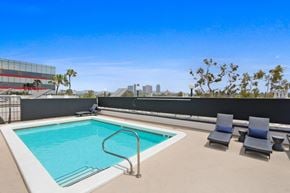 Century City apartment for rent - the pool on the rooftop of an apartment building with chairs and a pool