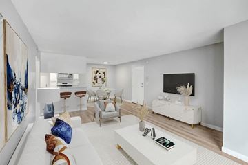Reseda apartment for rent - A modern living room with a white sofa and a coffee table.