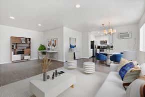 Beverly Hills apartment for rent - A modern living room with a white sofa and a coffee table.