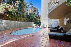 Hancock Park apartment for rent - A small pool with a metal fence around it.