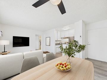 Tarzana apartment for rent - A modern living room with a wooden table and a bowl of fruit on it.