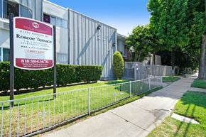 Canoga Park apartment for rent - a fence in front of a building with a sign on it