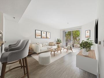 Hancock Park apartment for rent - A living room with a grey chair and a white sofa.
