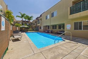 Northridge apartment for rent - A small pool surrounded by a concrete patio and a building.