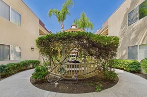 Northridge apartment for rent - A tree-covered gazebo is in the middle of a courtyard.