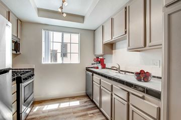 Los Angeles apartment for rent - A kitchen with a stove top oven and a window.