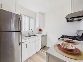 Mission Hills apartment for rent - A modern kitchen with a stainless steel refrigerator and white cabinets.