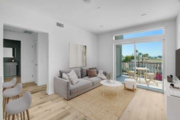 Winnetka apartment for rent - a living room with a couch and a table and a balcony