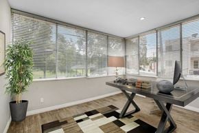 Beverly Hills apartment for rent - a home office with a large window and a large potted plant