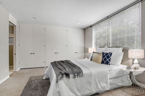 Beverly Hills apartment for rent - a bedroom with a large bed and white cabinets