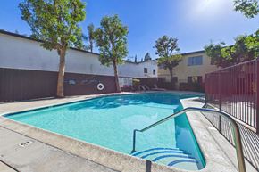 Van Nuys apartment for rent - A small pool with a metal railing and steps leading into it.