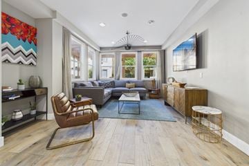 Chatsworth apartment for rent - A modern living room with a brown leather chair and a grey sofa.