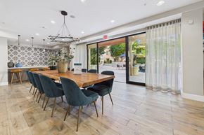 Chatsworth apartment for rent - A dining room with a long table and chairs.