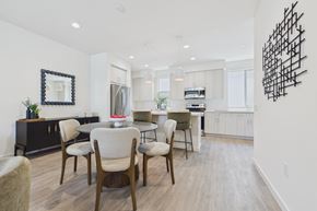 Granada Hills apartment for rent - A modern dining room with a wooden table and chairs.