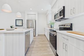 Granada Hills apartment for rent - A modern kitchen with white cabinets and stainless steel appliances.
