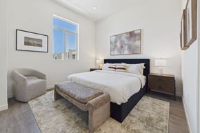 Granada Hills apartment for rent - A bedroom with a large bed and a chair.