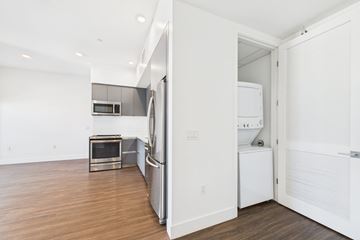 Los Angeles apartment for rent - A white refrigerator is in a kitchen with a microwave and oven.