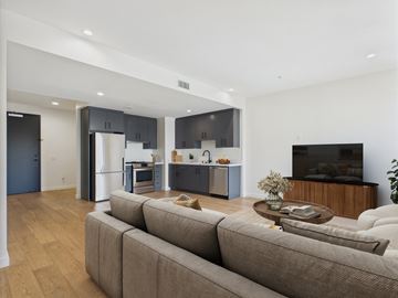 Los Angeles apartment for rent - A modern living room with a grey sofa and a wooden coffee table.