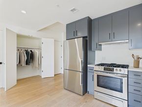 Los Angeles apartment for rent - A kitchen with a stainless steel refrigerator and oven, and wooden flooring.