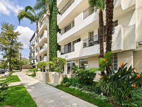 Los Angeles apartment for rent - A white apartment building with a green lawn in front.