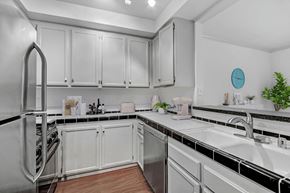 Los Angeles apartment for rent - the preserve at ballantyne commons apartment kitchen with white cabinets and stainless steel appliances